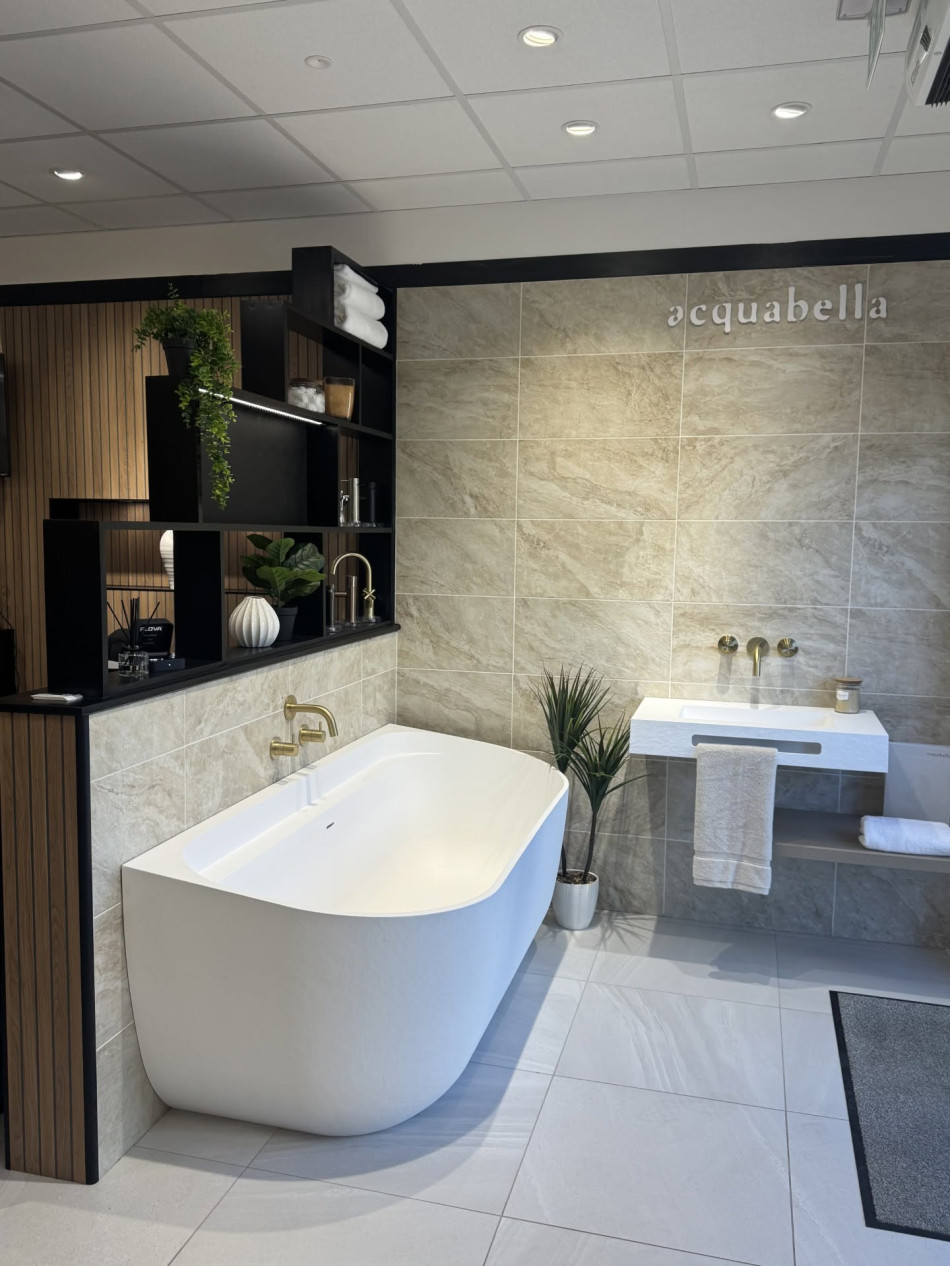 A spacious bathroom featuring a large bathtub and a modern sink, designed for comfort and relaxation
